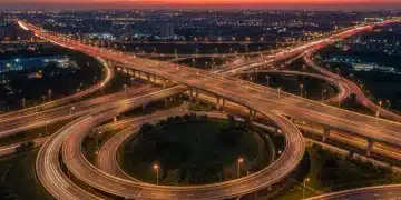 Modern highway interchange at dusk, symbolizing advanced US transportation infrastructure